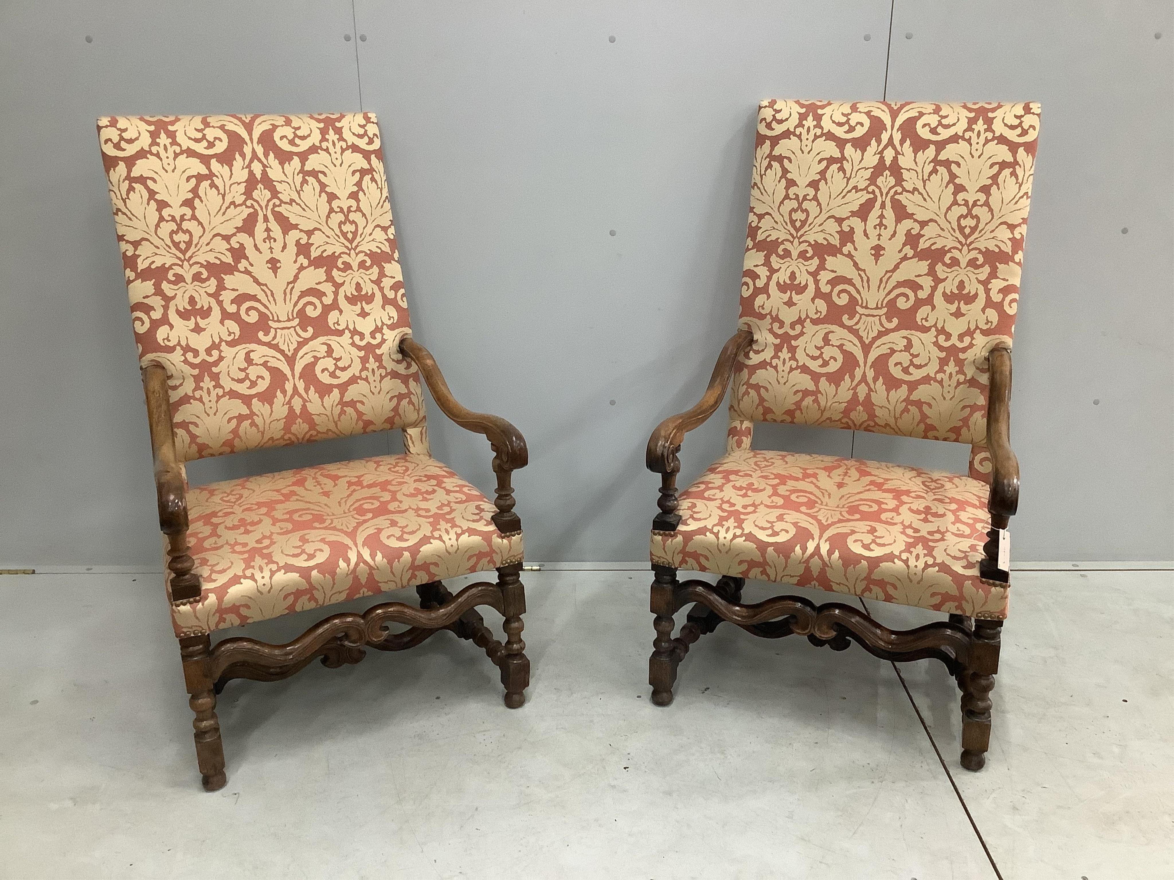 A pair of Louis XIV style walnut open armchairs, width 66cm, height 121cm. Condition - light rubbing to arms otherwise good